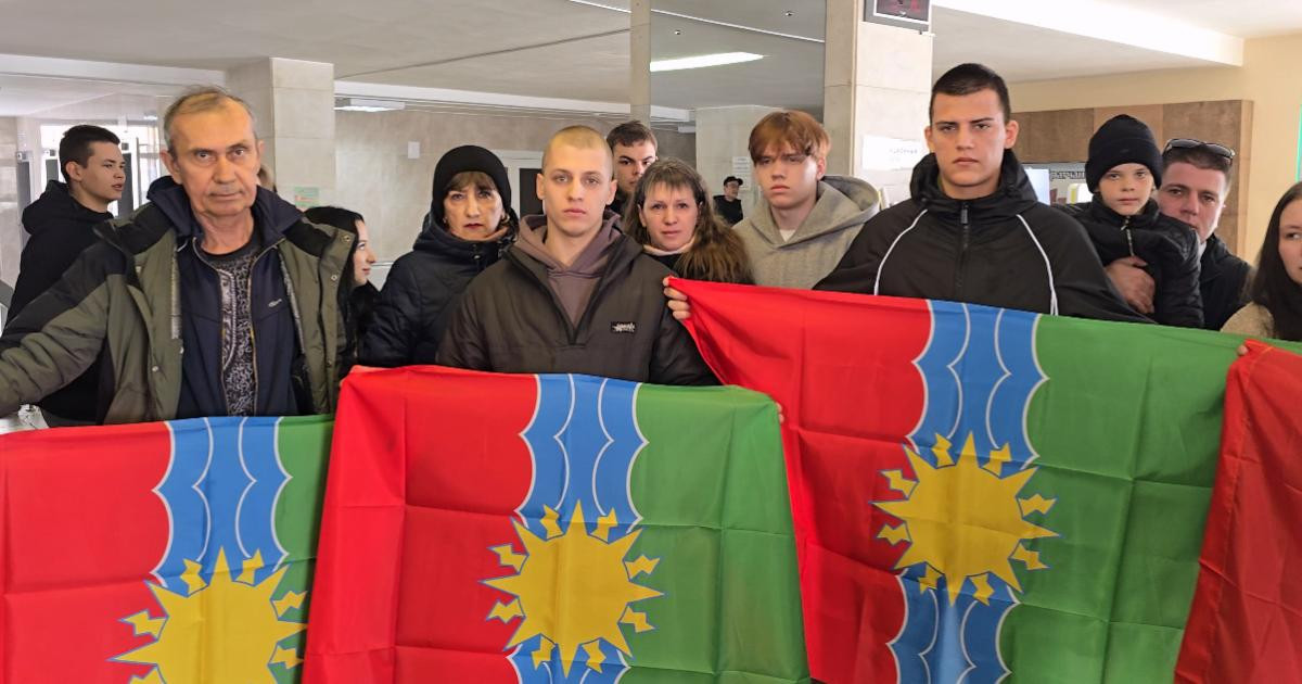 Группа людей с красно-зелеными флагами