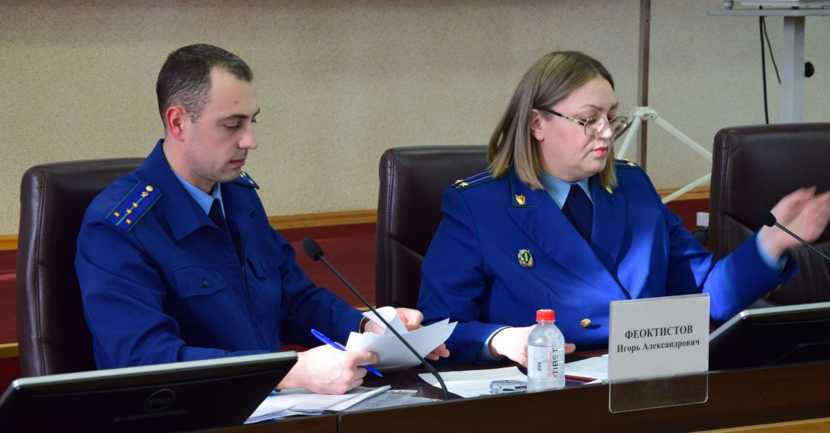 Два человека в форме на собрании.