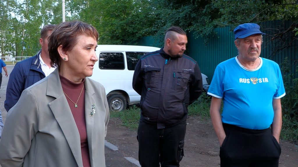 Люди стоят на улице рядом с автомобилем