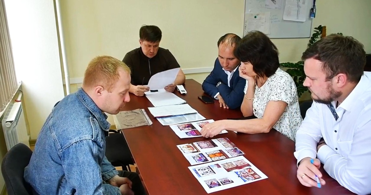 Группа людей обсуждает проект за столом.